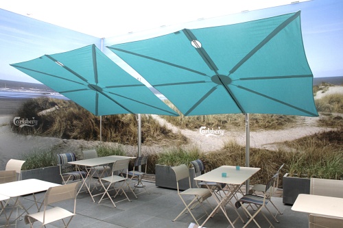 SP25100SET Spectra Solo Umbrella and Paver Base on outdoor dining area with sea grass and sand dunes partial water view and blue sky in background