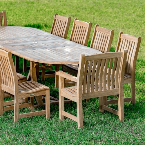 70008 Montserrat Veranda eleven piece teak oval dining set side angle view on a grass field 