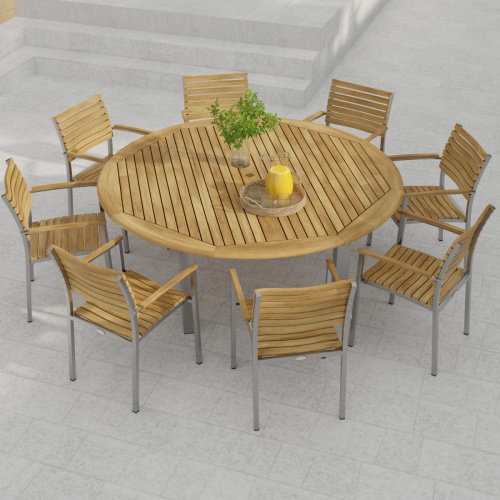 70111 Vogue teak and stainless steel 9 piece72 inch round Dining Set with a vase and a teak tray with a pitcher and 2 glasses in angled view of table top on marble stone patio
