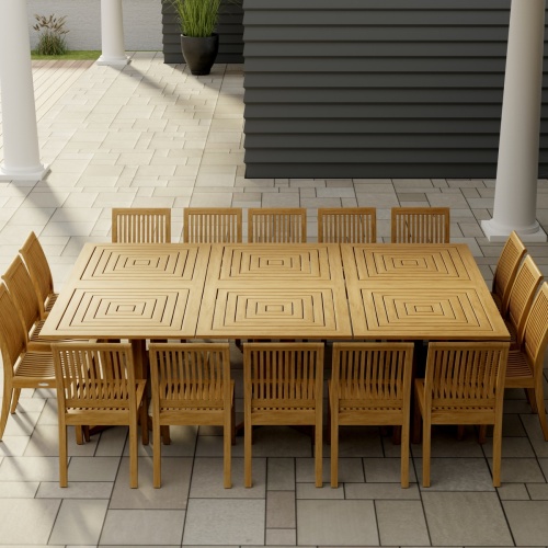 70288 Pyramid Teak Dining Set for 16  in corner view on covered patio next to a potted plant with house in the background