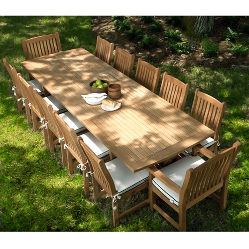 70017 Grand Veranda 13 piece dining set with optional seat cushions in aerial view showing bowl of apples plate of bread serving plates and bowls on a grass lawn