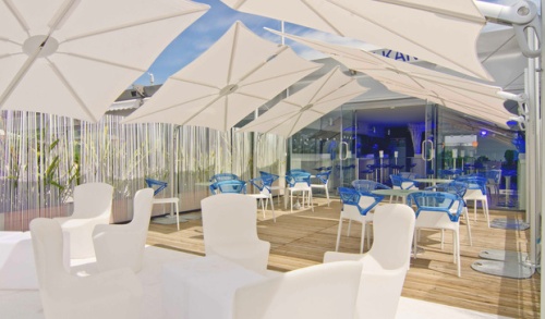 image of SPS2590SFB Spectra umbrella with canvas color top covering various chairs
