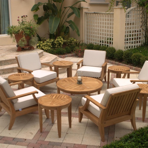 12152 laguna teak chair set in circular setting on outdoor paver patio aerial view surrounded by tropical foliage with home and lattice fence background
