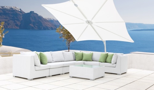 SP25100SET Spectra Solo Umbrella and Paver Base on outdoor terrace over sectional and coffee table against concrete balcony with land ocean and blue sky in background